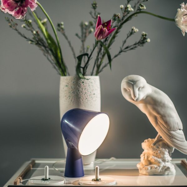 Binic table lamp by Foscarini in aquamarine, showcasing playful design and soft downward light.