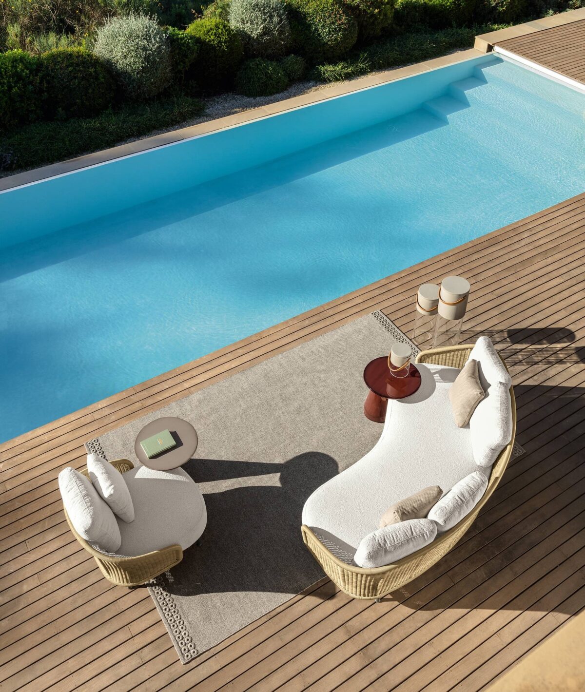 Designer Nido Swivel Armchair by Talenti with high backrest and soft fabric in a Troy, Michigan garden setting