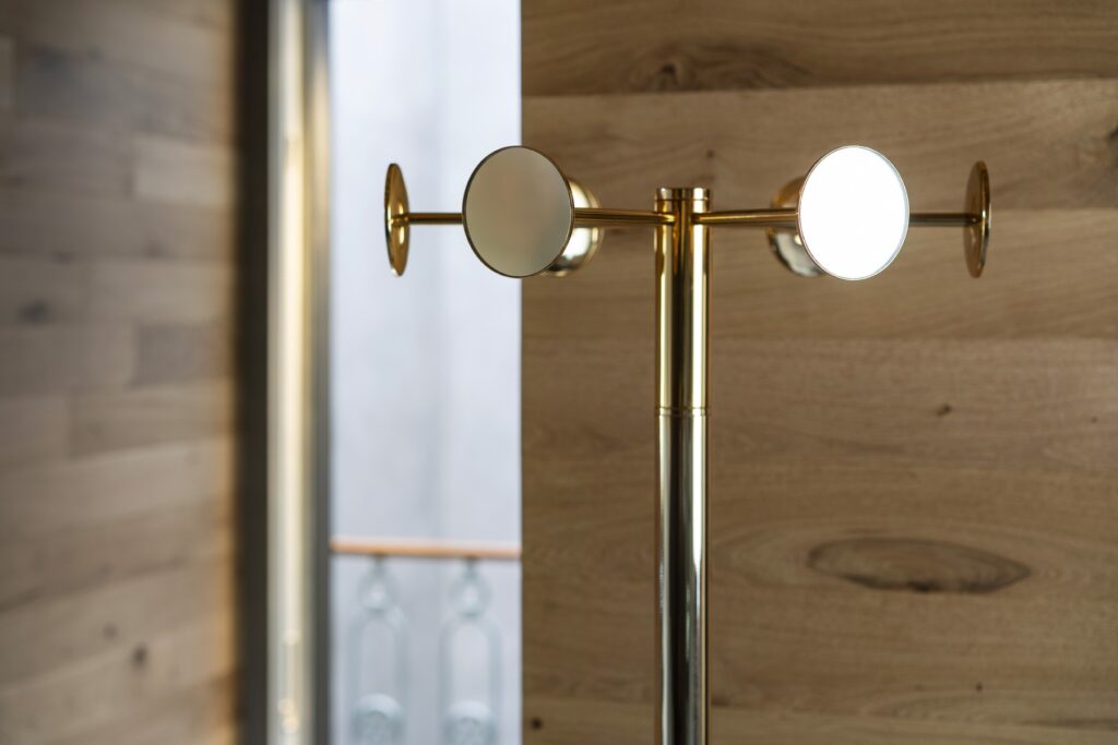 Chaperon by Opinion Ciatti in chrome finish, 18-mirror revolving coat stand, displayed in Royal Oak, Michigan.