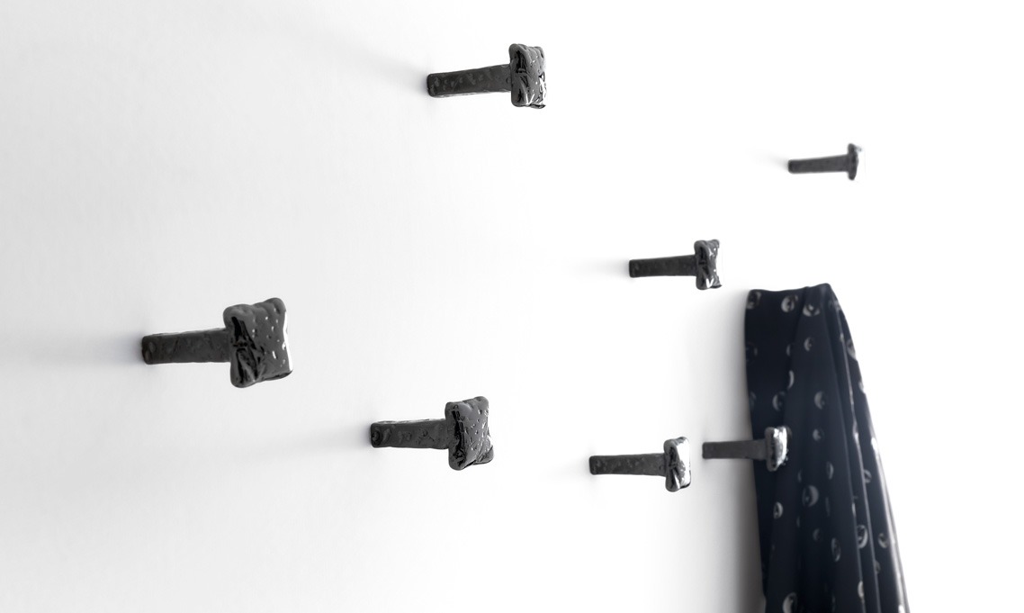 Chiodo Schiaccia Chiodo Nail by Opinion Ciatti in black nickel finish, wall-mounted minimalist coat hook, displayed in Royal Oak, Michigan.