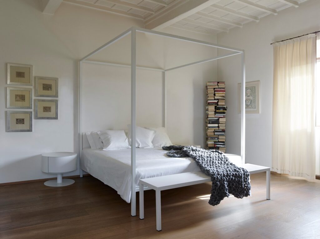 ILletto canopy bed by Opinion Ciatti in gold leaf finish with upholstered headboard, showcased in Royal Oak, Michigan.
