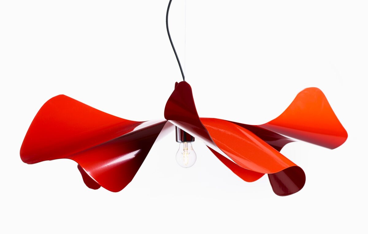This lamp is inspired by the delicate petals of a poppy flower and is crafted from hand-folded stainless steel or brass, available in various finishes including red, white, and gold.