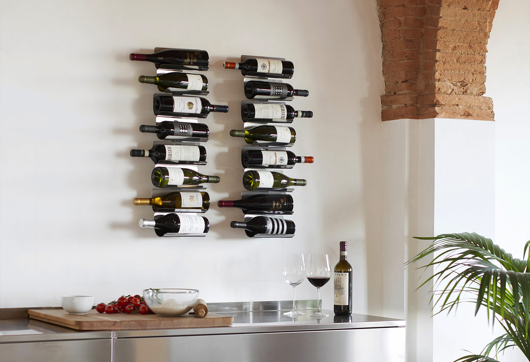Ptolomeo Vino Wall vertical wall-mounted wine rack by Opinion Ciatti in matte black lacquered steel, featuring minimalist design with slip-resistant elastic bands to securely hold up to 22 bottles, showcased in Royal Oak, Michigan showroom.
