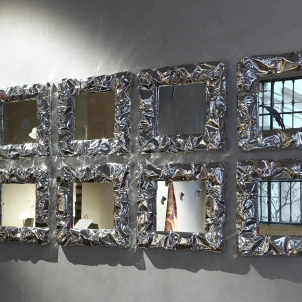 Enhance your Birmingham, Michigan space with the Tab.u Mirror by Opinion Ciatti, featuring a frame inspired by the crumpled texture of aluminum foil, adding a modern touch to your decor.