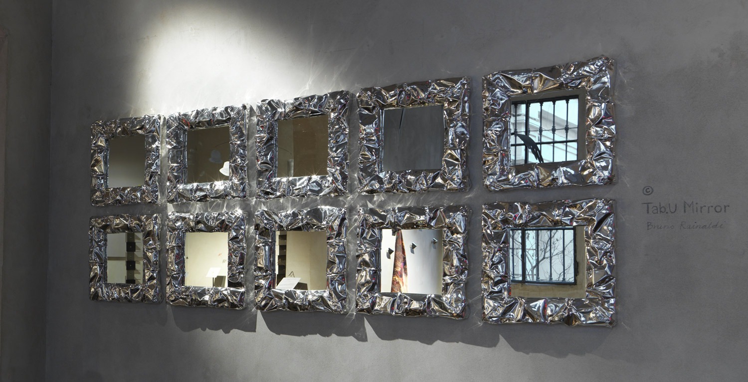 Enhance your Birmingham, Michigan space with the Tab.u Mirror by Opinion Ciatti, featuring a frame inspired by the crumpled texture of aluminum foil, adding a modern touch to your decor.