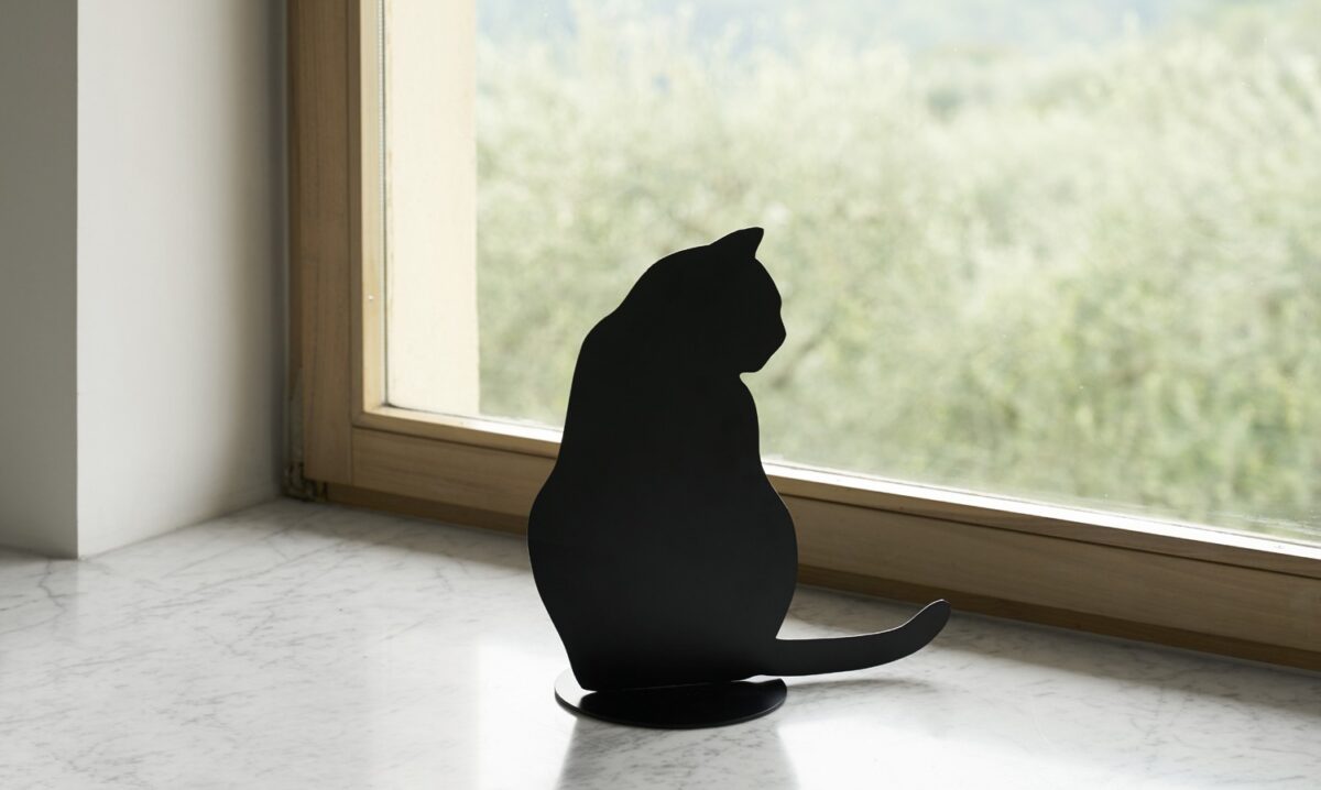 Ombres de Chats #4 steel sculpture by Angelo Barcella in black RAL 9005 finish, serving as a bookend, displayed in Royal Oak, Michigan.