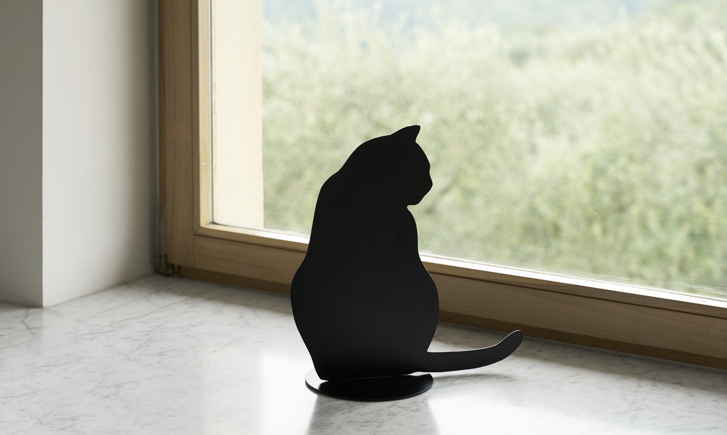 Ombres de Chats #4 steel sculpture by Angelo Barcella in black RAL 9005 finish, serving as a bookend, displayed in Royal Oak, Michigan.