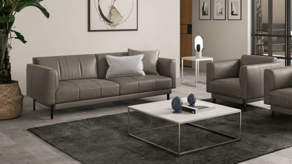 Levante sofa by Natuzzi Italia in leather, featuring sleek vertical stitching and slim metal legs, displayed in Royal Oak, Michigan showroom.