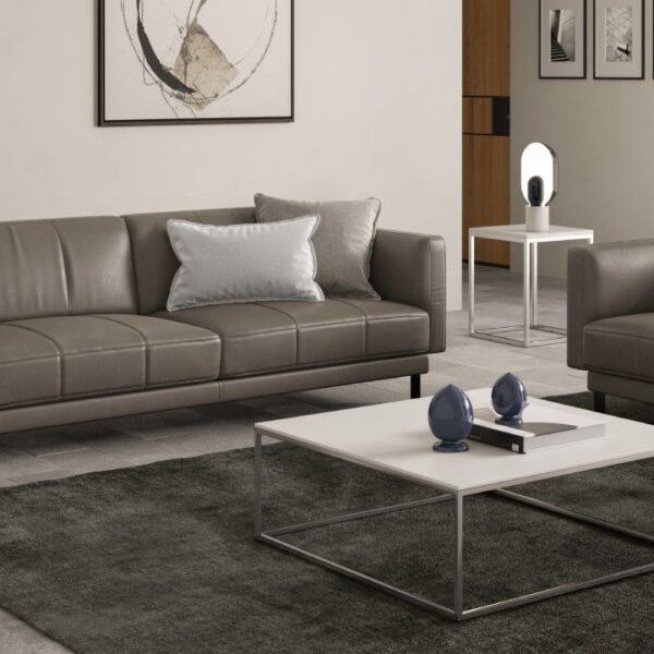 Levante sofa by Natuzzi Italia in leather, featuring sleek vertical stitching and slim metal legs, displayed in Royal Oak, Michigan showroom.