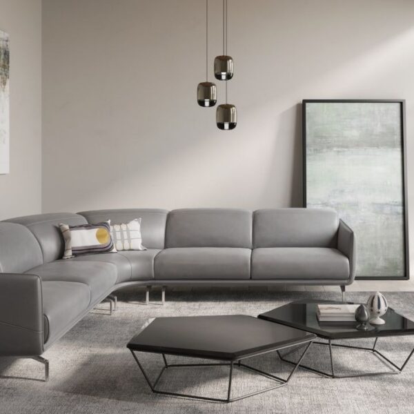 Valzer modular sofa by Natuzzi Italia with leather upholstery, adjustable headrests, and metal feet in glossy chrome finish, displayed in Royal Oak, Michigan.