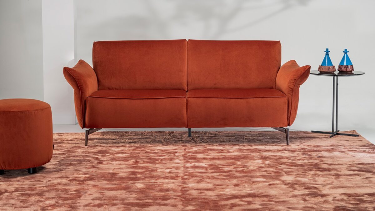 Milano sofa by Natuzzi Italia in dark brown leather with padded armrests and black chrome metal feet, displayed in Royal Oak, Michigan.