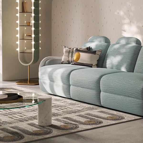 Calilla sofa by Natuzzi Italia with leather external frame and BYBORRE Coral fabric seat and backrest, featuring brass-plated metal base, displayed in Royal Oak, Michigan.