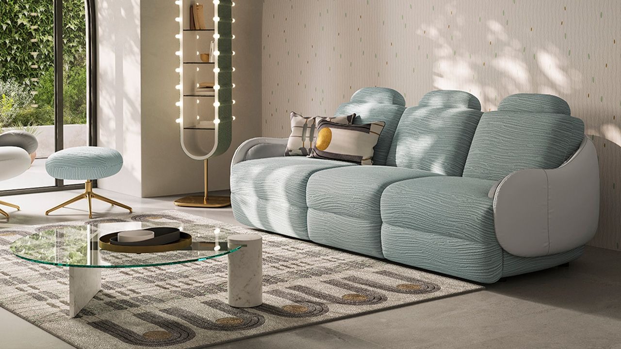 Calilla sofa by Natuzzi Italia with leather external frame and BYBORRE Coral fabric seat and backrest, featuring brass-plated metal base, displayed in Royal Oak, Michigan.