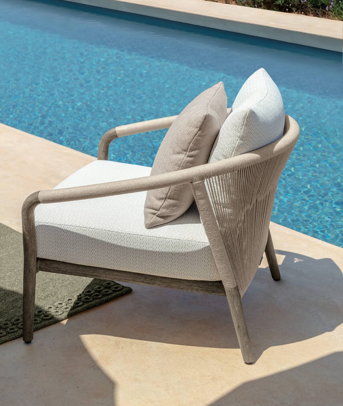Talenti Parker Sofa, a two-seater outdoor sofa featuring a sleek teak wood frame and neutral fabric cushions for a minimalist aesthetic.