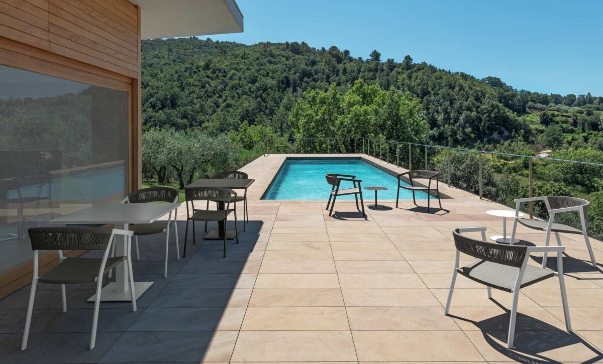 Italian-made Key Living Armchair by Talenti with minimalist frame and soft outdoor fabric cushions