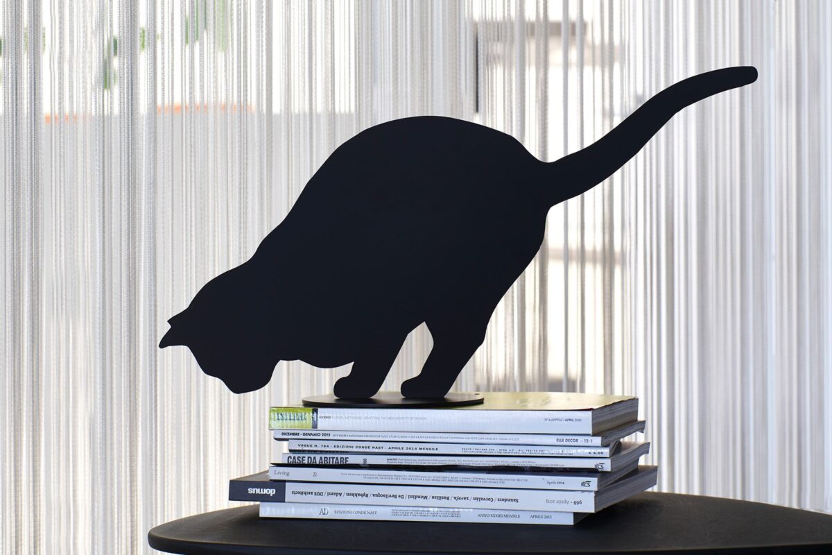 Ombres de Chats #4 steel sculpture by Angelo Barcella in black RAL 9005 finish, serving as a bookend, displayed in Royal Oak, Michigan.
