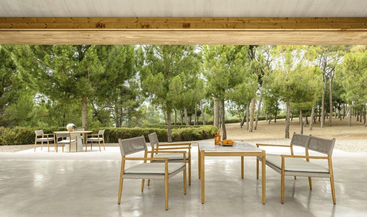 Talenti Dolcevita Love Seat in a modern outdoor living area with decorative pillows