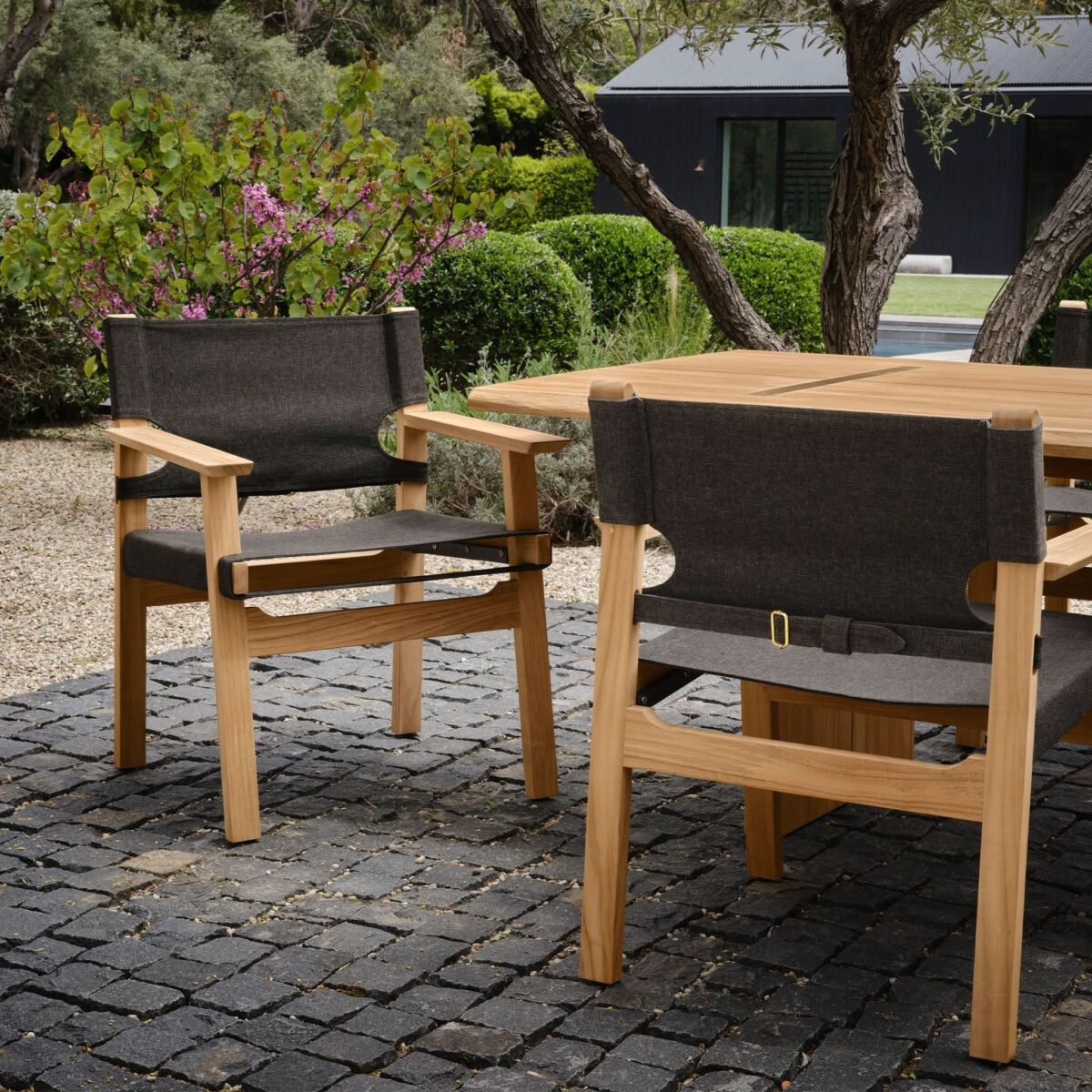 “Top-down view of long teak dining surface – comfortably seats 8 for outdoor entertaining”