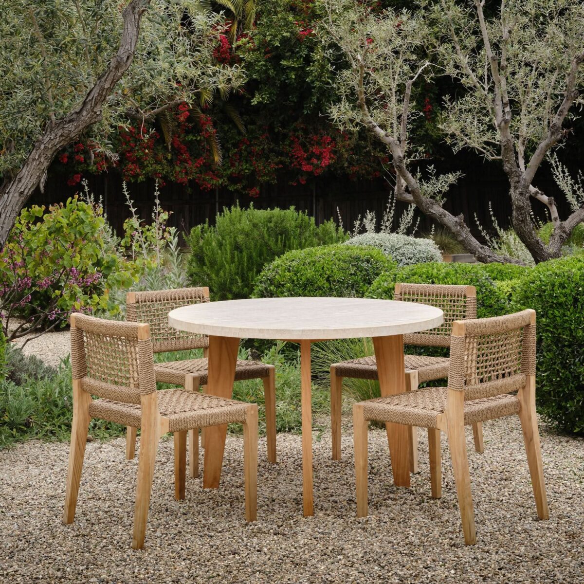 “Round teak dining table in outdoor setting – timeless, durable, and weather-resistant”