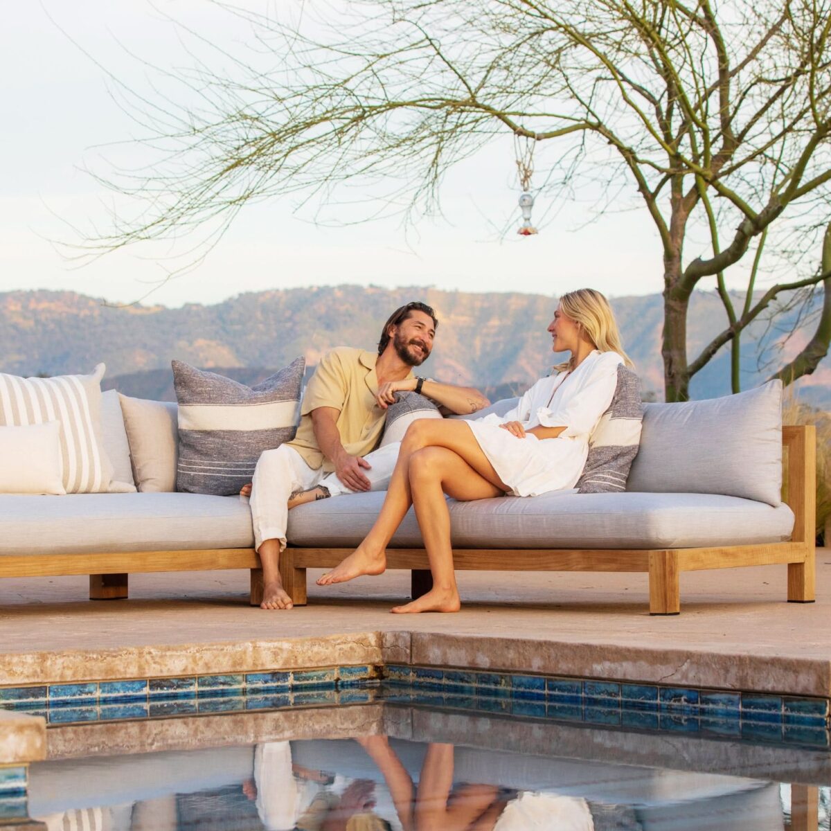 “Back view of Harbour Pacific 2 Seat Armless Sofa – streamlined teak frame with open sides”