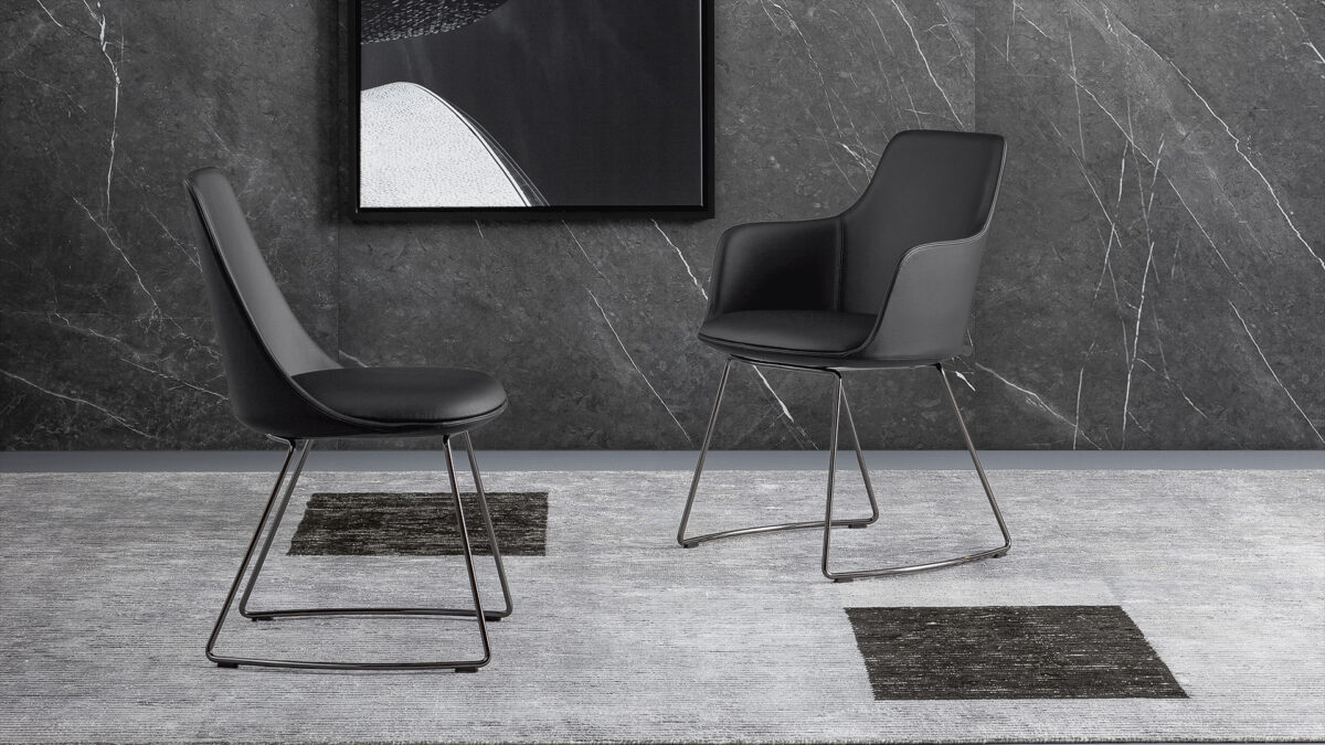 "Miss Record chair by Bonaldo featuring padded armrests and soft fabric upholstery with metal base."