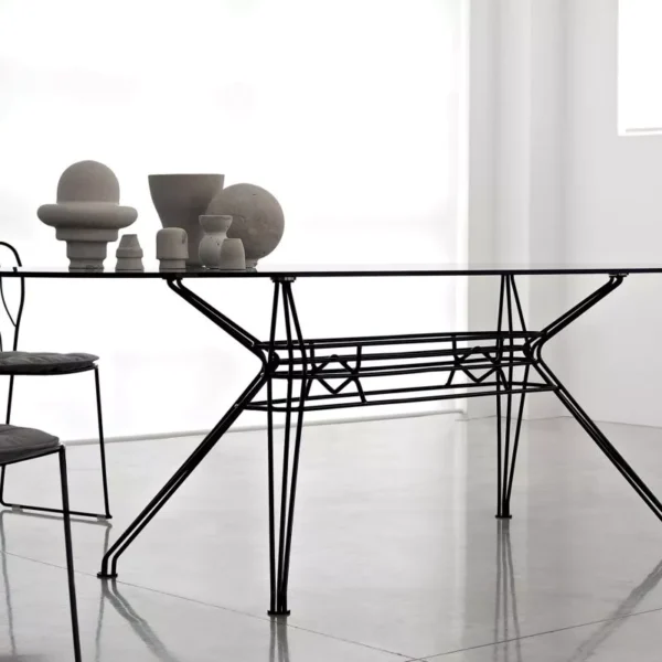 Sander Outdoor dining table by Bontempi Casa with white lacquered metal frame and transparent extra‑clear glass top on a garden terrace.