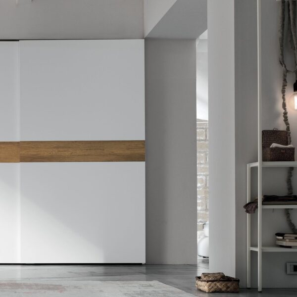 "Tablet Sliding by Tomasella – elegant bedroom wardrobe with textured front panels and integrated handle details"