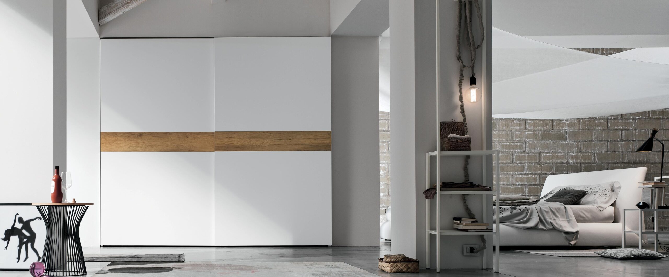 "Tablet Sliding by Tomasella – elegant bedroom wardrobe with textured front panels and integrated handle details"