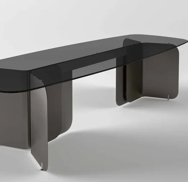 Pleat dining table by Tonelli Design with extra-clear glass top and metallic champagne metal base, displayed in Royal Oak, Michigan.
