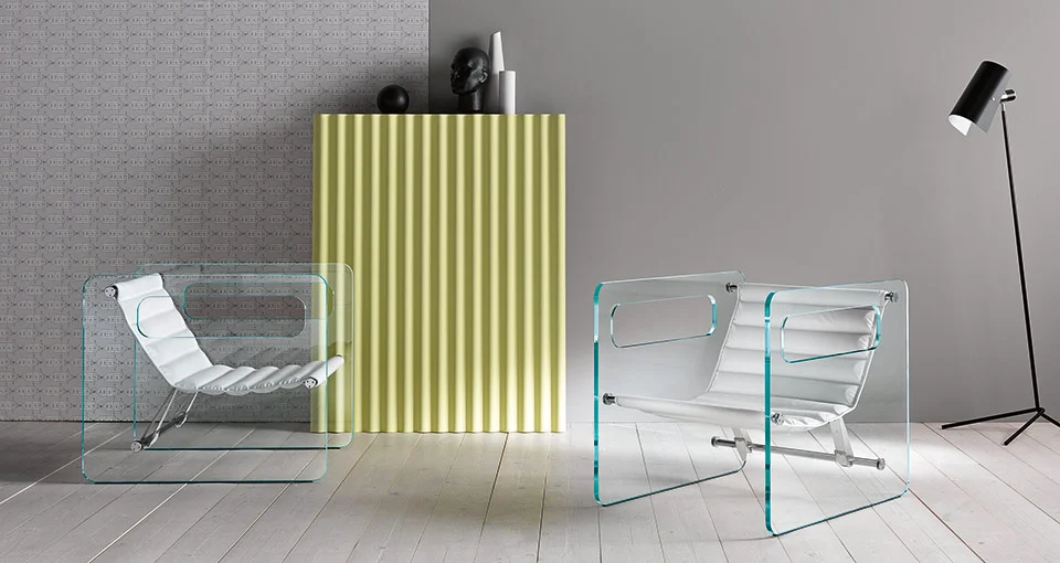 Modern Italian glass armchair Naked by Tonelli Design, featuring transparent or extra-clear glass panels with cutout armrests and a black leather seat, available in Royal Oak, Michigan.