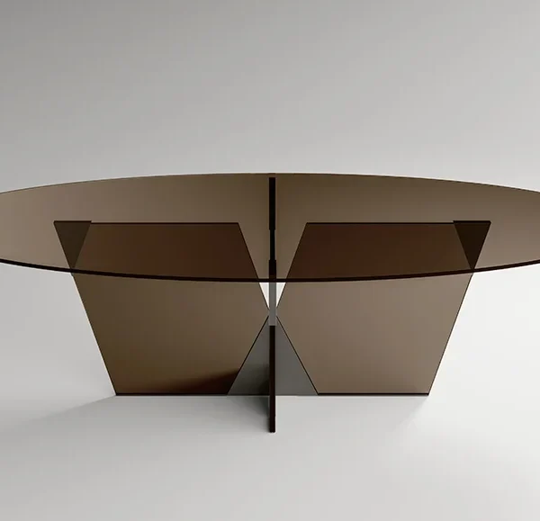 Crossover dining table by Tonelli Design with extra-clear glass top and pyramidal metal joint in polished gunmetal finish, displayed in Royal Oak, Michigan.