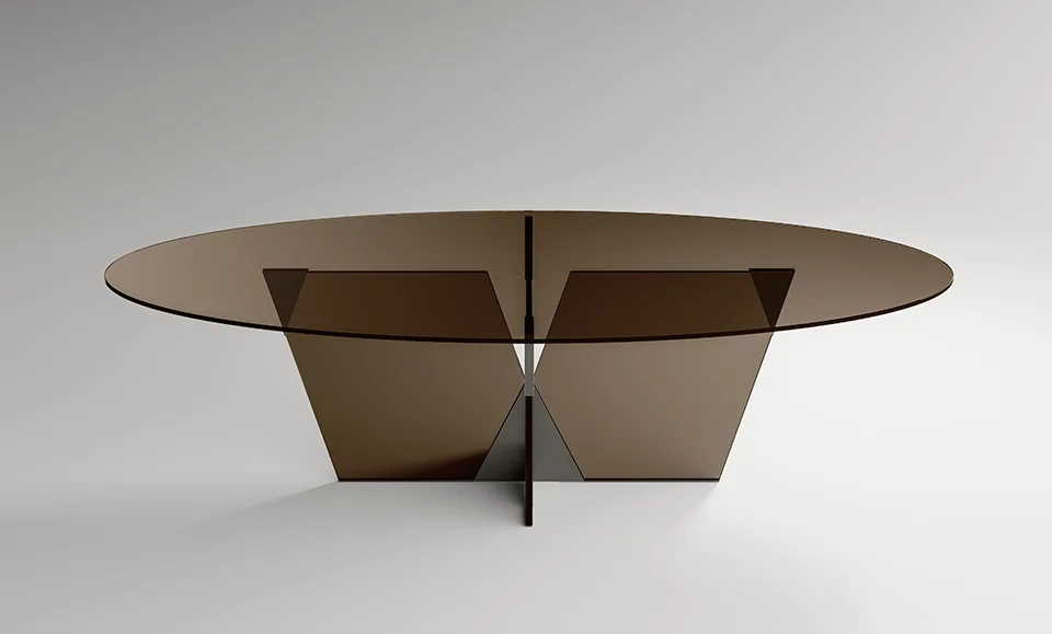 Crossover dining table by Tonelli Design with extra-clear glass top and pyramidal metal joint in polished gunmetal finish, displayed in Royal Oak, Michigan.