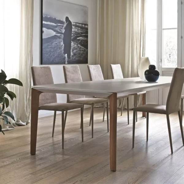Minimalist Versus fixed table by Bontempi – white velvet-matt glass top and charcoal oak legs in a bright interior.