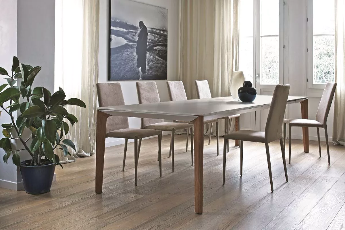 Minimalist Versus fixed table by Bontempi – white velvet-matt glass top and charcoal oak legs in a bright interior.