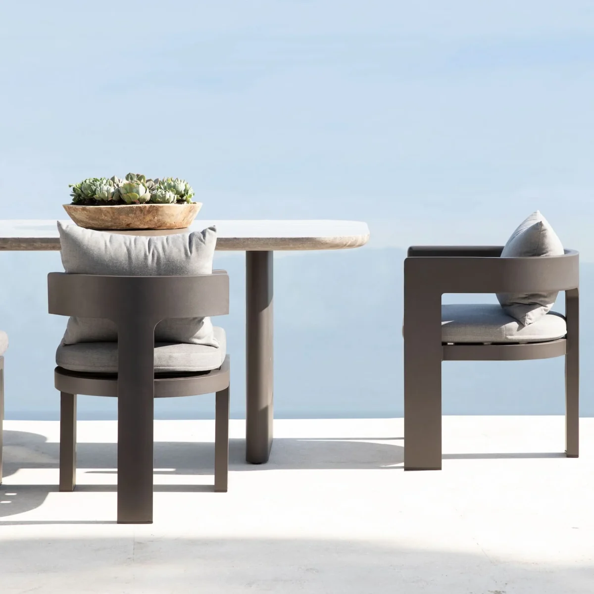 “Victoria 108" dining table by Harbour styled with aluminum chairs – luxury alfresco setting”